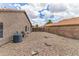 Low maintenance backyard features gravel landscaping and block wall fencing, offering privacy and functionality at 1672 W Butler Dr, Chandler, AZ 85224