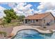 Inviting backyard features a private pool, covered patio, fire pit, and lush landscaping; perfect for outdoor living at 1672 W Butler Dr, Chandler, AZ 85224