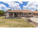 Backyard with a covered patio, a fire pit, mature landscaping, and a glimpse of the home's architecture at 1672 W Butler Dr, Chandler, AZ 85224