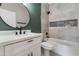 Modern bathroom featuring a quartz countertop, sleek fixtures, and a tiled shower with a decorative niche at 1672 W Butler Dr, Chandler, AZ 85224