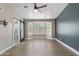 Large room featuring a fan, sliding barn door to bath, and a bay window to let in plenty of natural light at 1672 W Butler Dr, Chandler, AZ 85224