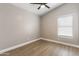 Neutral bedroom boasts wood-look flooring, natural light and ceiling fan at 1672 W Butler Dr, Chandler, AZ 85224