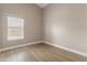 Neutral-toned bedroom offers a window, wood-look flooring and is ready for personalization at 1672 W Butler Dr, Chandler, AZ 85224