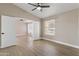 Spacious bedroom with ceiling fan, wood-look flooring, neutral walls and a connected room at 1672 W Butler Dr, Chandler, AZ 85224