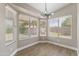 Bright dining area featuring wood-look flooring, neutral walls and large windows with backyard views at 1672 W Butler Dr, Chandler, AZ 85224