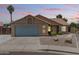 Inviting single-story home featuring desert landscaping, a two-car garage, and a mature palm tree against a picturesque sky at 1672 W Butler Dr, Chandler, AZ 85224