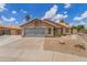 Attractive single-story house boasting desert landscaping, a two-car garage, and a quaint entryway under a bright sky at 1672 W Butler Dr, Chandler, AZ 85224