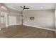Open living space featuring wood-look flooring, neutral walls, and an open doorway to another room at 1672 W Butler Dr, Chandler, AZ 85224