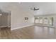 Bright living area with wood-look flooring, neutral walls, recessed lighting, and sliding glass doors leading to the outdoors at 1672 W Butler Dr, Chandler, AZ 85224