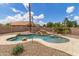 Inviting pool with rock features, surrounded by lush landscaping and a spacious deck, creating a relaxing oasis at 1672 W Butler Dr, Chandler, AZ 85224