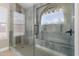 Beautiful walk-in shower featuring elegant tile work, a built-in bench, and glass enclosure at 1672 W Butler Dr, Chandler, AZ 85224