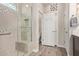 Modern bathroom featuring tiled walk-in shower with bench, glass door, and neutral color palette at 16756 S 181St Ln, Goodyear, AZ 85338