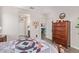 Cozy bedroom featuring wood floors, a decorative bedspread, and ample storage with a wooden dresser at 16756 S 181St Ln, Goodyear, AZ 85338