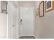 Bright entryway with white door, coat closet and decorative mirror at 16756 S 181St Ln, Goodyear, AZ 85338