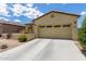 Charming home featuring desert landscaping, covered porch, and a two-car garage at 16756 S 181St Ln, Goodyear, AZ 85338