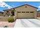 Charming home featuring desert landscaping, covered porch, and a two-car garage at 16756 S 181St Ln, Goodyear, AZ 85338