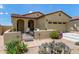 Charming home with desert landscaping, secure gated front patio, and two-car garage at 16756 S 181St Ln, Goodyear, AZ 85338
