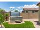 A backyard hot tub sits on pavers in a tranquil setting with privacy walls and a small green lawn at 16756 S 181St Ln, Goodyear, AZ 85338