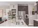 Kitchen area featuring a large pantry with shelving, stainless steel refrigerator and an island sink at 16756 S 181St Ln, Goodyear, AZ 85338
