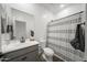 Bathroom featuring a gray vanity, a shower-tub combo, a black faucet and modern finishes at 16824 W Alice Ave, Waddell, AZ 85355