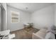 Bright bedroom with a work desk, a comfortable chair, and a cozy sofa bed at 16824 W Alice Ave, Waddell, AZ 85355