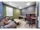 Office/Bedroom featuring custom paint, modern furniture, and a cozy seating area at 16824 W Alice Ave, Waddell, AZ 85355