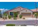 Charming home featuring a low-maintenance desert landscape, complemented by vibrant flowering bushes at 16824 W Alice Ave, Waddell, AZ 85355