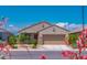 Beautiful home with low-maintenance landscaping and colorful flowering shrubs enhancing its curb appeal at 16824 W Alice Ave, Waddell, AZ 85355