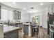 Modern kitchen with granite countertops, gray cabinets, and stainless steel appliances at 16824 W Alice Ave, Waddell, AZ 85355