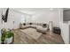 Inviting living room with wood-look floors, a large sectional, and stylish decor at 16824 W Alice Ave, Waddell, AZ 85355