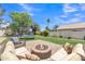 Inviting backyard featuring a fire pit, trampoline, and well-maintained lawn at 17425 N 1St Dr, Phoenix, AZ 85023