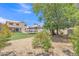 Lush backyard with gravel, a trampoline, and a view of the home and trees at 17425 N 1St Dr, Phoenix, AZ 85023