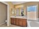 Bathroom with double sinks, soaking tub, and natural light at 17425 N 1St Dr, Phoenix, AZ 85023