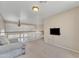 Bright loft area featuring neutral decor, a ceiling fan, and a mounted television at 17425 N 1St Dr, Phoenix, AZ 85023