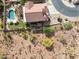 Aerial view of the property showcasing the backyard pool, covered patio, and the surrounding desert landscape at 18121 E San Luis Dr, Gold Canyon, AZ 85118