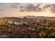 Scenic aerial view of homes in a desert community, framed by mountains and a picturesque sky at 18121 E San Luis Dr, Gold Canyon, AZ 85118
