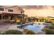 Outdoor backyard with a pristine pool and covered patio area at 18121 E San Luis Dr, Gold Canyon, AZ 85118