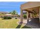 Expansive backyard with a covered patio, lush lawn, and a sparkling pool, perfect for outdoor enjoyment at 18121 E San Luis Dr, Gold Canyon, AZ 85118