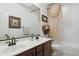 Bright bathroom with double sinks, decorative shower curtain, and framed mirror at 18121 E San Luis Dr, Gold Canyon, AZ 85118