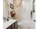 Well-lit bathroom with a combination tub and shower, framed mirror, and double sink at 18121 E San Luis Dr, Gold Canyon, AZ 85118