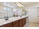 Bright bathroom with a double vanity, tile flooring, and white cabinets at 18121 E San Luis Dr, Gold Canyon, AZ 85118