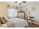 Inviting bedroom featuring an iron bed, ceiling fan, and charming decorative accents at 18121 E San Luis Dr, Gold Canyon, AZ 85118