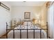 Relaxing bedroom with an iron bed frame, bedside table, and floral accents at 18121 E San Luis Dr, Gold Canyon, AZ 85118