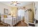 Cozy bedroom featuring a comfortable iron bed, ceiling fan, and soft natural light at 18121 E San Luis Dr, Gold Canyon, AZ 85118