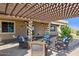 Charming covered patio area with comfortable seating, providing an inviting space for relaxation and entertaining at 18121 E San Luis Dr, Gold Canyon, AZ 85118