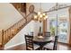 Charming dining area with wood floors and staircase adjacent, featuring a chandelier and access to outdoor patio at 18121 E San Luis Dr, Gold Canyon, AZ 85118