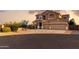 Spacious two-story home featuring a three-car garage and well-manicured landscaping at 18121 E San Luis Dr, Gold Canyon, AZ 85118