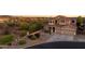 Beautiful two-story home with desert landscaping and a three-car garage at 18121 E San Luis Dr, Gold Canyon, AZ 85118