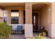 Inviting front porch with comfortable seating and desert landscaping at 18121 E San Luis Dr, Gold Canyon, AZ 85118