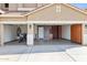 Home's garage featuring an epoxy floor, motorcycle, storage cabinets, and a water heater at 18121 E San Luis Dr, Gold Canyon, AZ 85118